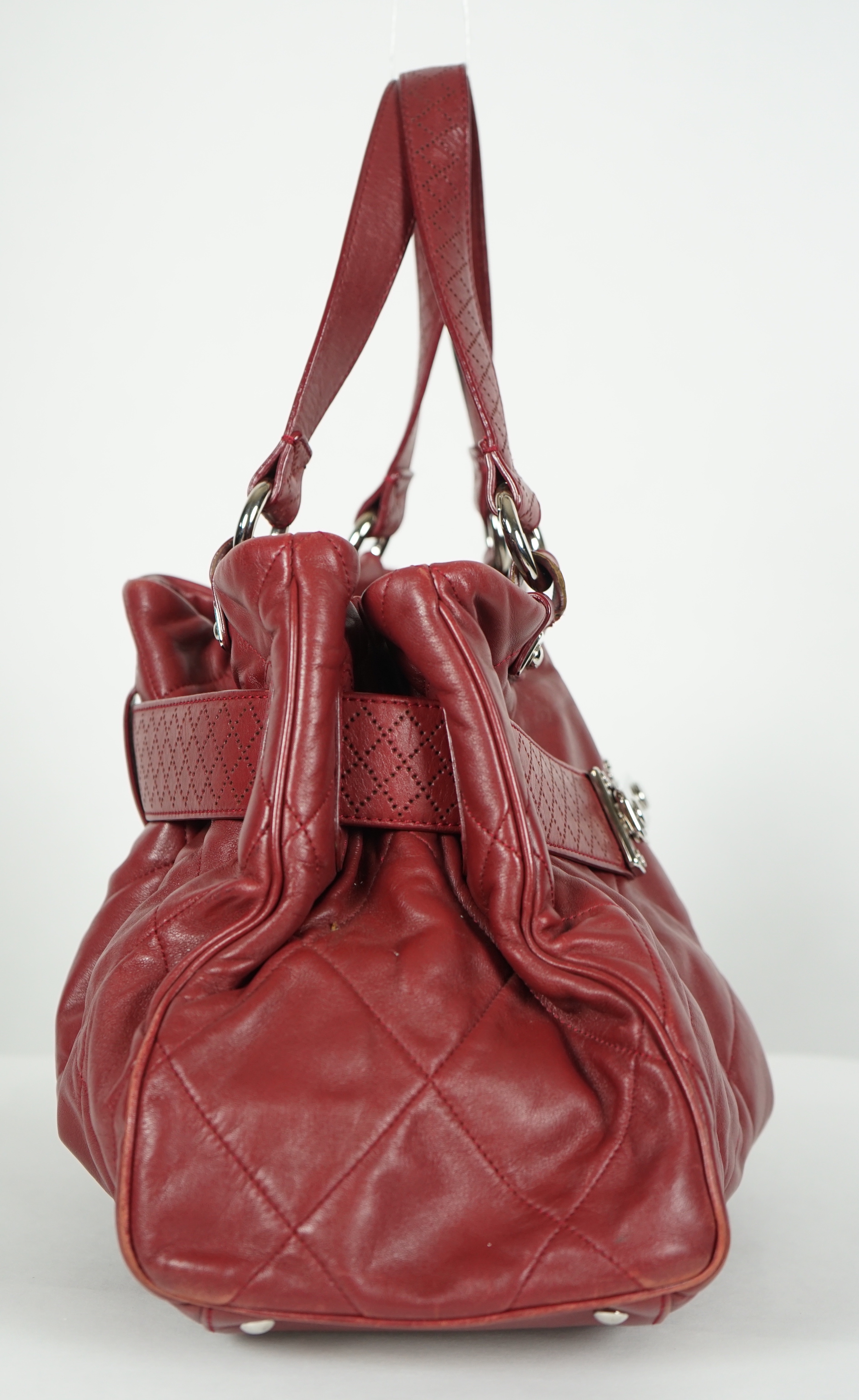 A Chanel burgundy leather buckled handle bag, with dust bag, height: 24.5cm, height overall 44cm, width 45cm, depth 16.5cm, Please note this lot attracts an additional import tax of 20% on the hammer price